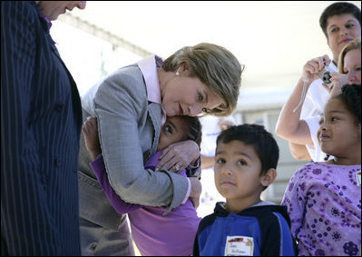 Laura Bush gives a hug to a student at Delisle Elementary School in Pass Christian, Miss., Tuesday, Oct. 11, 2005, as the school reopened for the first time since the area was struck by Hurricane Katrina.