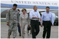 President George W. Bush and Laura Bush walk with Lt. General Russel Honore, left, and Plaquemines Parish president Benny Rousselle, right, upon their arrival Monday, Oct. 10, 2005 at the U.S. Naval Air Station, Joint Reserve Base in New Orleans, La.