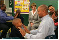 Laura Bush watches fathers play a game with their children in the R.E.A.D. to Kids Training Program at J.S. Chick Elementary School in Kansas City, Mo., Tuesday, October 11, 2005.