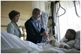 President George W. Bush and Mrs. Laura Bush talk with Sgt. Patrick Hagood of Anderson, S.C., Wednesday, Oct. 5, 2005, during their visit to Walter Reed Army Medical Center in Washington D.C.