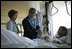 President George W. Bush and Mrs. Laura Bush talk with Sgt. Patrick Hagood of Anderson, S.C., Wednesday, Oct. 5, 2005, during their visit to Walter Reed Army Medical Center in Washington D.C.