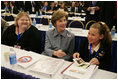 Laura Bush sits with Michaela Huberty, right, and her mentor, Jennifer Kalenborn, left, Thursday, Oct. 27, 2005 at Howard University in Washington, at the White House Conference on Helping America's Youth.