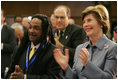 Laura Bush and Louie Culver give Culver's daughter, Sarah Tucker, a standing ovation at the completion of her award winning essay, Thursday, Oct. 27, 2005 at Howard University in Washington, at the White House Conference on Helping America's Youth.