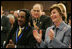 Laura Bush and Louie Culver give Culver's daughter, Sarah Tucker, a standing ovation at the completion of her award winning essay, Thursday, Oct. 27, 2005 at Howard University in Washington, at the White House Conference on Helping America's Youth.