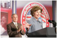 President George W. Bush, background, applauds as Mrs. Bush offers her welcoming remarks, Thursday, Oct. 27, 2005 at Howard University in Washington, at the White House Conference on Helping America's Youth.