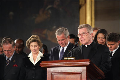 President George W. Bush and Laura Bush participate in a prayer led by Reverend Daniel Coughlin, House Chaplain, in honor of Rosa Parks during a wreath-laying ceremony in the Rotunda of the U.S. Capitol in Washington, D.C., Sunday Oct. 30, 2005. Rosa Parks passed away Monday, Oct. 24th.