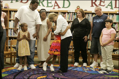 Laura Bush embraces a child Thursday, Sept. 8, 2005 of one of the families from New Orleans, displaced last week as a result of Hurricane Katrina, during a meeting at the Greenbrook Elementary School in DeSoto County, Miss. Greenbrook Elementary School has enrolled the most displaced students among the DeSoto County schools in Mississippi.