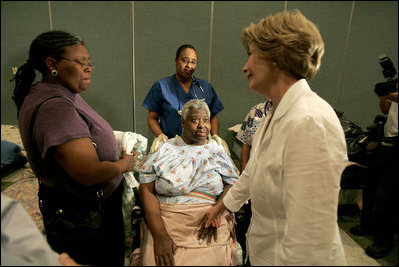 Laura Bush reaches out to a victim of Hurricane Katrina during a visit Friday, Sept. 2, 2005, to the Cajundome at the University of Louisiana in Lafayette. "The people of this part of the United States, the Lafayette area of Louisiana, are very, very warm people," said Mrs. Bush. "They've opened their hearts, and many of them have opened their homes, as well, to people from New Orleans -- family members and strangers."