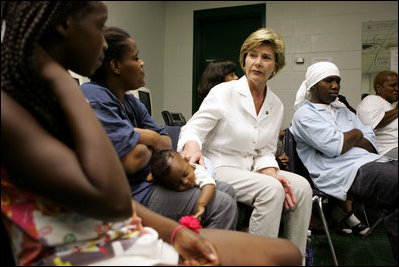 Laura Bush visits with people affected by Hurricane Katrina in the Cajundome at the University of Louisiana in Lafayette, La., Friday, Sept. 2, 2005.