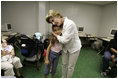 First Lady Laura Bush hugs a young girl displaced by Hurricane Katrina during her visit Friday, Sept. 2, 2005, to the Cajundome at the University of Louisiana in Lafayette. "Some things are working very, very well in Louisiana," Mrs. Bush said. "And certainly this center is one of those..."