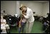 First Lady Laura Bush hugs a young girl displaced by Hurricane Katrina during her visit Friday, Sept. 2, 2005, to the Cajundome at the University of Louisiana in Lafayette. "Some things are working very, very well in Louisiana," Mrs. Bush said. "And certainly this center is one of those..."