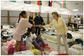 Laura Bush visits people affected by Hurricane Katrina at the Bethany World Prayer Center shelter, Monday, Sept. 5, 2005 in Baton Rouge, Louisiana, where hundreds of people have taken refuge.