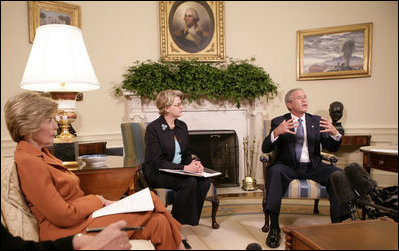 President George W. Bush, seen with U.S. Secretary of Education Margaret Spellings, center, and Laura Bush, left, gestures as he speaks with reporters, Tuesday, Sept. 6, 2005 in the Oval Office at the White House, about efforts the Department of Education is undertaking with a program, "Hurricane Help for Schools," established to assist schools and students affected by Hurricane Katrina.