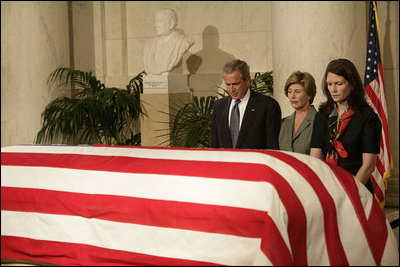 President George W. Bush and Laura Bush pay their respects to Chief Justice William Rehnquist as his body lies in repose in the Great Hall of the U.S. Supreme Court Tuesday, Sept. 6, 2005. Standing as honor guard for the Chief Justice is one of his former law clerks, Courtney Ellwood.