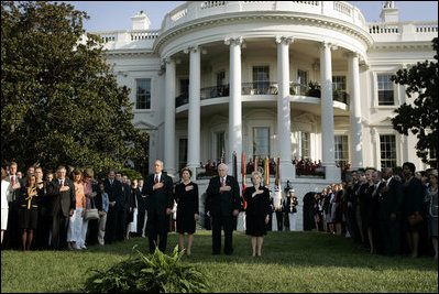 President Bush stands with Laura Bush, Vice President Dick Cheney and Mrs. Cheney as they observe a moment of silence, on the South Lawn, in honor of 9/11 victims September 11, 2005. This marks the fourth anniversary of terrorist attacks on both the World Trade Center and The Pentagon.