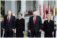 President Bush stands with Laura Bush, Vice President Dick Cheney and Mrs. Cheney as they observe a moment of silence, on the South Lawn, in honor of 9/11 victims September 11, 2005. This marks the fourth anniversary of terrorist attacks on both the World Trade Center and The Pentagon.