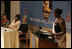 Laura Bush listens to Jeannette Kagame, the First Lady of Rwanda and President of the Organization of African First Ladies Against HIV/AIDS, addresses the group in New York Thursday, Sept. 15, 2005.