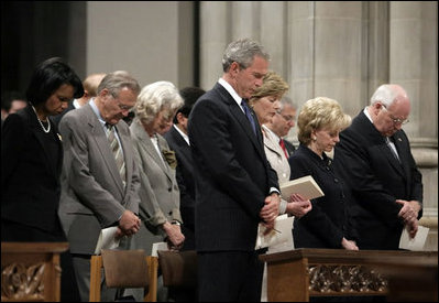 President George W. Bush bows his head in prayer during the National Day of Prayer and Remembrance Service at the Washington National Cathedral in Washington, D.C., Friday, Sept. 16, 2005. Also pictured are Laura Bush, Lynne Cheney Vice President Cheney, Secretary Rice and Secretary Rumsfeld.