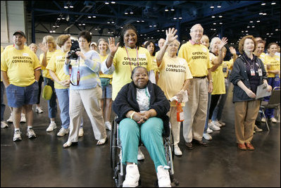 "Operation Compassion" volunteers wave to First Lady Laura Bush Monday, Sept. 19, 2005, as she visited Houston's George R. Brown Convention Center. The Convention Center was designated a shelter for Hurricane Katrina evacuees and since opening its doors Sept. 2, more than 35,000 have been served and approximately 46,000 volunteers have been trained.