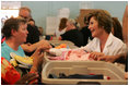 Laura Bush meets with people while visiting a clothing distribution site at the Biloxi Community Center, Tuesday, Sept. 27, 2005 in Biloxi, Miss., where she also interviewed with the television program, ABC's Extreme Makeover: Home Edition.