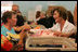 Laura Bush meets with people while visiting a clothing distribution site at the Biloxi Community Center, Tuesday, Sept. 27, 2005 in Biloxi, Miss., where she also interviewed with the television program, ABC's Extreme Makeover: Home Edition.