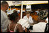 Laura Bush helps give out meals to families, while visiting a medical and food distribution site, Tuesday, Sept. 27, 2005 in Biloxi, Miss.