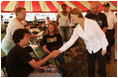 Laura Bush meets with people while visiting a medical and food distribution site, Tuesday, Sept. 27, 2005 in Biloxi, Miss.