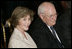 Laura Bush and Vice President Dick Cheney sit together, Thursday, Sept. 29, 2005, during the swearing-in ceremony for John G. Roberts, Jr., Chief Justice of the United States Supreme Court, in the East Room of the White House.