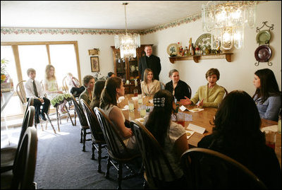 Mrs. Laura Bush visits with high school girls who are living in a family-style residential group home at Father Flanagan's Girls & Boys Town in Omaha, NE, Monday, April 3, 2006. The program applies a behavior treatment model for delinquent youths ages 10-18 that emphasizes positive relationships, teaching skills, self control, while supporting moral and spiritual development and promoting self-government and self-determination.