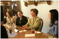 Mrs. Laura Bush shares in laughter with girls who are living in a family-style residential group home at Father Flanagan's Girls & Boys Town in Omaha, NE, Monday, April 3, 2006. Girls and Boys Town was founded in 1917 to help troubled boys. Today there are more than 100 long-term, residential-care homes for trouble youths, featuring family-style living in the least restrictive environment.