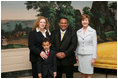 Mrs. Laura Bush poses for a photo with Sal Tinajero, his wife Jennifer and son Salvador, Thursday, April 6, 2006, in the Diplomatic Room at the White House. Mr. Tinajero, a high school teacher in Santa Ana, CA, is the recipient of Hispanic Magazine's Teacher of the Year award, which recognizes him as a single outstanding educator within the Hispanic community by means of motivating, inspiring and preparing his students for a promising future.