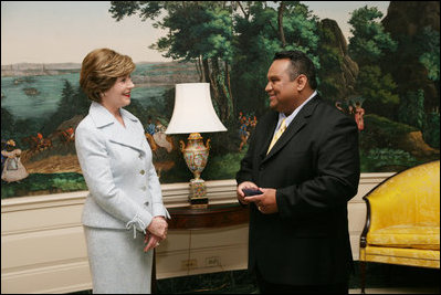 Mrs. Laura Bush enjoys a moment with Sal Tinajero Thursday, April 6, 2006, recipient of Hispanic Magazine's Teacher of the Year award in the Diplomatic Room at the White House. Along with being a World History teacher, Mr. Tinajero resurrected the Speech and Debate team at Fullerton Union High School in Santa Ana, California.