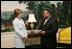 Mrs. Laura Bush enjoys a moment with Sal Tinajero Thursday, April 6, 2006, recipient of Hispanic Magazine's Teacher of the Year award in the Diplomatic Room at the White House. Along with being a World History teacher, Mr. Tinajero resurrected the Speech and Debate team at Fullerton Union High School in Santa Ana, California.