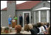 Mrs. Laura Bush, joined by former President George H.W. Bush, Mrs. Barbara Bush, and family friend, Joe O'Neill, speaks to the crowd on Tuesday, April 11, 2006, during a dedication and ribbon cutting ceremony for the opening of President George W. Bush’s Childhood Home in Midland, Texas.