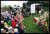 Mrs. Laura Bush reads a story to children attending the 2006 White House Easter Egg Roll, Monday, April 17, 2006 on the South Lawn of the White House.