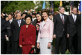 Mrs. Laura Bush stands with Liu Yongqing, the wife of Chinese President Hu Jintao, during the South Lawn Arrival Ceremony, Thursday, April 20, 2006.