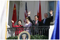 President George W. Bush, Chinese President Hu Jintao, Laura Bush and Hu's wife, Liu Yongqing, wave from the South Portico balcony after the South Lawn Arrival Ceremony at the White House, Thursday, April 20, 2006.