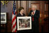 Mrs. Laura Bush is presented with a print by Dr. James Billington, the Librarian of Congress, showing an interior view of the White House as it looked in the early 1900s, Wednesday, April 26, 2006 during the James Madison Council Luncheon at the Library of Congress.