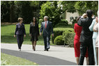 President George W. Bush and Mrs. Laura Bush accompany 2006 National Teacher of the Year Kim Oliver to the South Lawn ceremony in her honor Wednesday, April 26, 2006. Said the President of the Silver Spring, Maryland kindergarten teacher, "Kim Oliver understands that the key to helping children succeed is fighting the soft bigotry of low expectations."