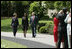 President George W. Bush and Mrs. Laura Bush accompany 2006 National Teacher of the Year Kim Oliver to the South Lawn ceremony in her honor Wednesday, April 26, 2006. Said the President of the Silver Spring, Maryland kindergarten teacher, "Kim Oliver understands that the key to helping children succeed is fighting the soft bigotry of low expectations."