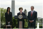 Mrs. Laura Bush addresses the audience Wednesday, April 26, 2006, as President Bush and Kim Oliver, the 2006 National Teacher of the Year, look on during a ceremony on the South Lawn honoring Ms. Oliver and the State Teachers of the Year.