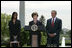 Mrs. Laura Bush addresses the audience Wednesday, April 26, 2006, as President Bush and Kim Oliver, the 2006 National Teacher of the Year, look on during a ceremony on the South Lawn honoring Ms. Oliver and the State Teachers of the Year.