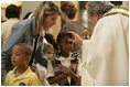 A young girl receives a blessing during a memorial Mass attended by President George W. Bush and Laura Bush at St. Louis Cathedral in New Orleans, Tuesday morning, Aug. 29, 2006, to commemorate the one- year anniversary of Hurricane Katrina.