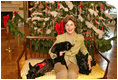 Mrs. Laura Bush poses with the family pets in the Blue Room in front of the White House Christmas Tree on December 1, 2006.