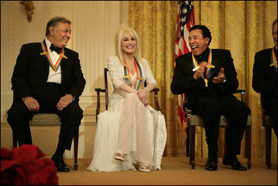 Conductor Zubin Mehta laughs with singers Dolly Parton and William "Smokey" Robinson during a reception for the Kennedy Center honorees in the East Room Sunday, Dec. 3, 2006.