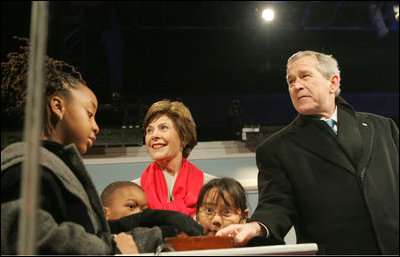 President Bush, Laura Bush: Lighting of the National Christmas Tree - Opening Ceremony for the 2006 Christmas Pageant of Peace. The Ellipse, Washington, D.C. President George W. Bush and Laura Bush are joined by Junior Rangers from the National Park Service program Thursday evening, Dec. 7, 2006, as they press the switch to light the National Christmas Tree on the Ellipse in Washington, D.C.