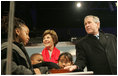 President Bush, Laura Bush: Lighting of the National Christmas Tree - Opening Ceremony for the 2006 Christmas Pageant of Peace. The Ellipse, Washington, D.C. President George W. Bush and Laura Bush are joined by Junior Rangers from the National Park Service program Thursday evening, Dec. 7, 2006, as they press the switch to light the National Christmas Tree on the Ellipse in Washington, D.C.