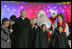 President George W. Bush and Laura Bush join entertainers Eartha Kitt, left, and Cathy Rigby, center, along with Santa Claus, invited children and The Singing Angels choir director Charles Eversole, right, on stage Thursday, Dec. 7, 2006, at the 2006 Christmas Pageant of Peace and the 83rd lighting of the National Christmas Tree on the Ellipse in Washington, D.C. 