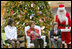 Mrs. Laura Bush sits with patient escorts Allison Meads, left, and Matthew Morgan, as she reads to an audience of children, patients and hospital staff Friday, Dec. 8, 2006, at The Children's National Medical Center in Washington, D.C., where Mrs. Bush visited with patients and debuted the 2006 Barney Cam video.