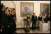 President George W. Bush and Laura Bush listen to Indiana University's A Cappella Choir, HooShir, sing during the lighting of the Menorah during the annual White House Hanukkah reception Monday, Dec. 18, 2006. Pictured at right is Ariel Cohen, 14, and her parents Dan and Rachel Cohen.